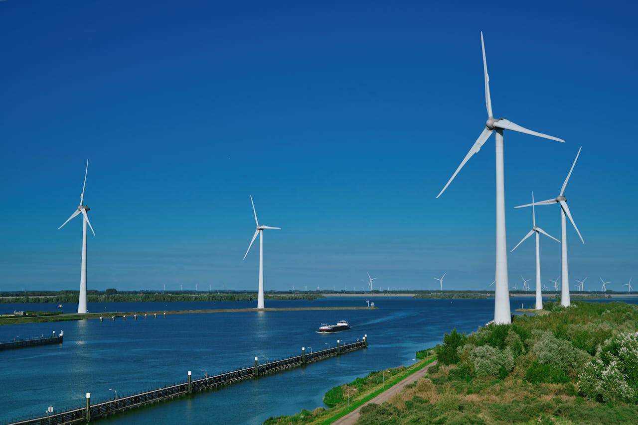 Mastering the First Impression: Your intriguing post title goes here Renewable wind energy turbines standing over water under a clear blue sky in Bruinisse.
